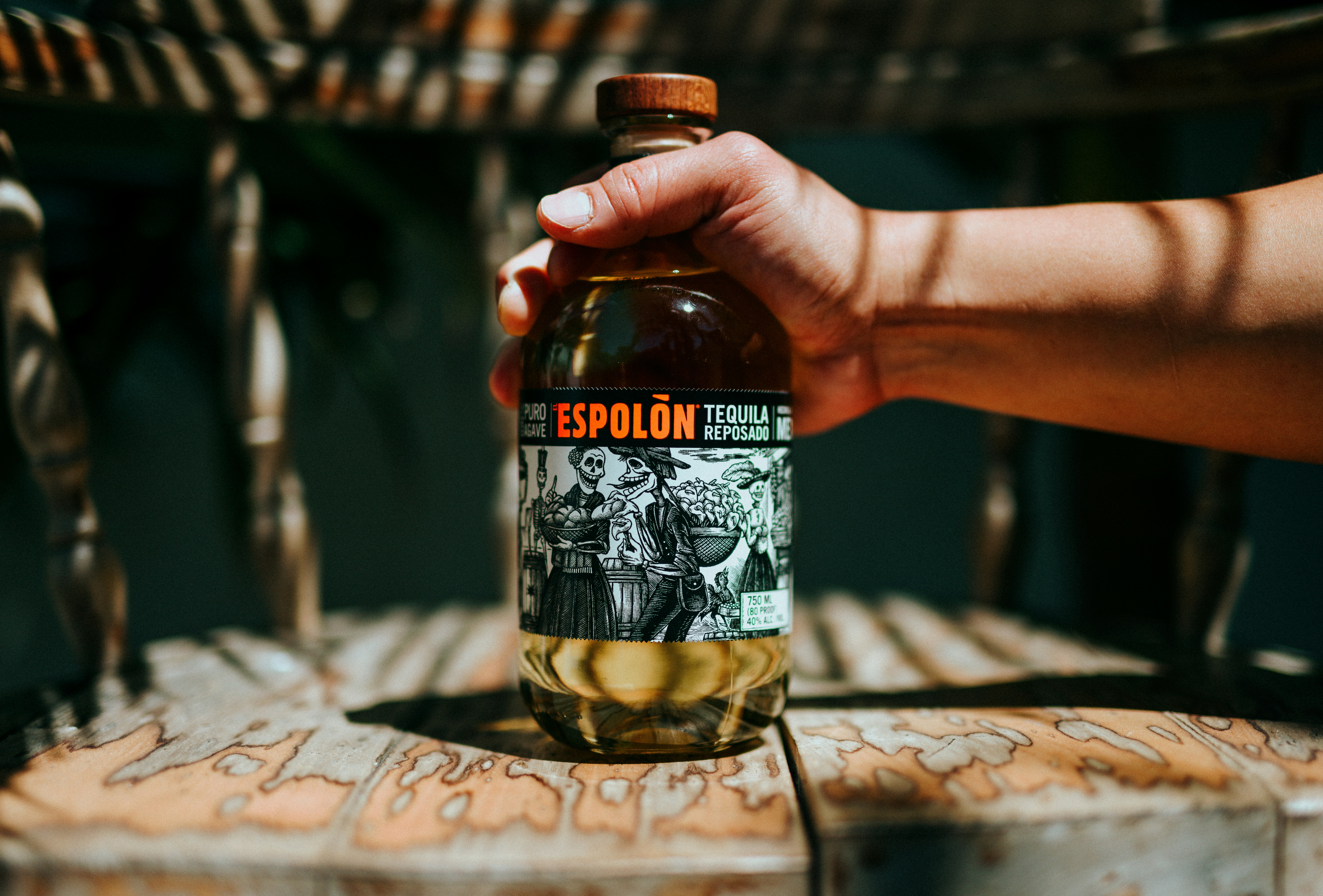 person holding Espolòn Tequila bottle